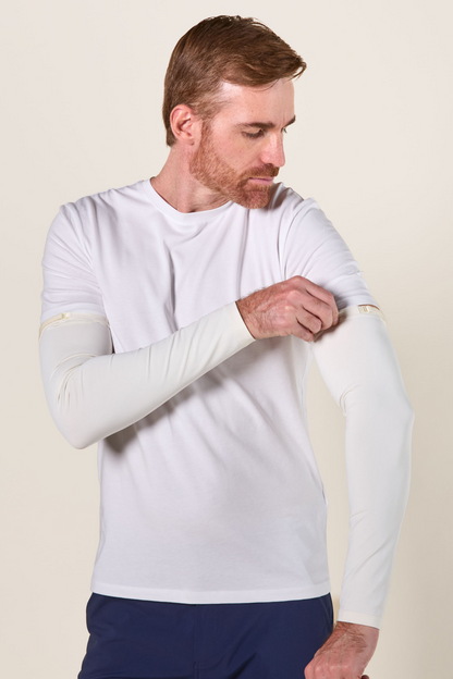 "Homme portant un t-shirt blanc anti-UV avec manches longues UPF50+, idéal pour la protection solaire."